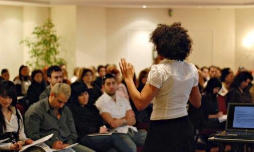 Presenter speaking to a seated audience at the milk_shake launch seminar